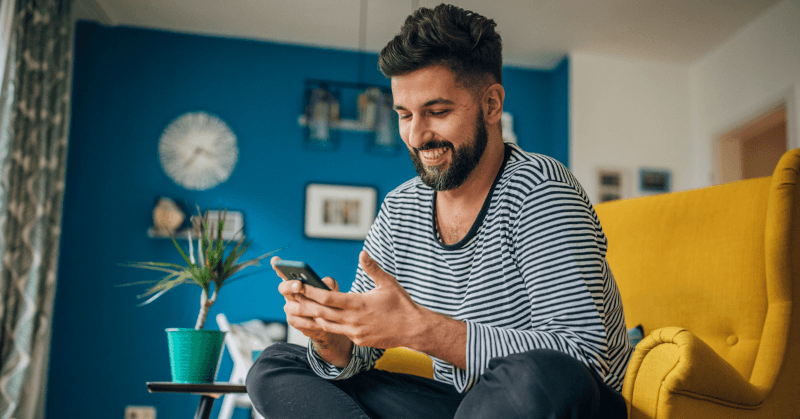 Person smiling looking at their phone