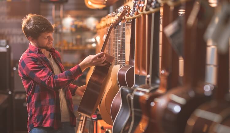 Person looking at guitars